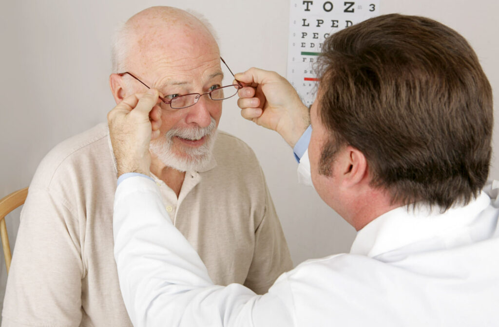 A senior man gets his newly prescribed eyeglasses from an ophthalmologist.